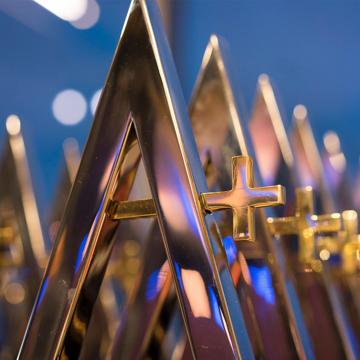 A row of golden FundGrade A+ awards lined up