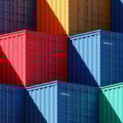 Stacked, colourful shipping containers, visually representing the concept of diversified assets or income sources.
