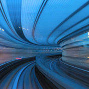 Abstract image of a fast-moving journey through a blue-lit tunnel, symbolizing forward momentum, data flow, and the velocity of modern funds.