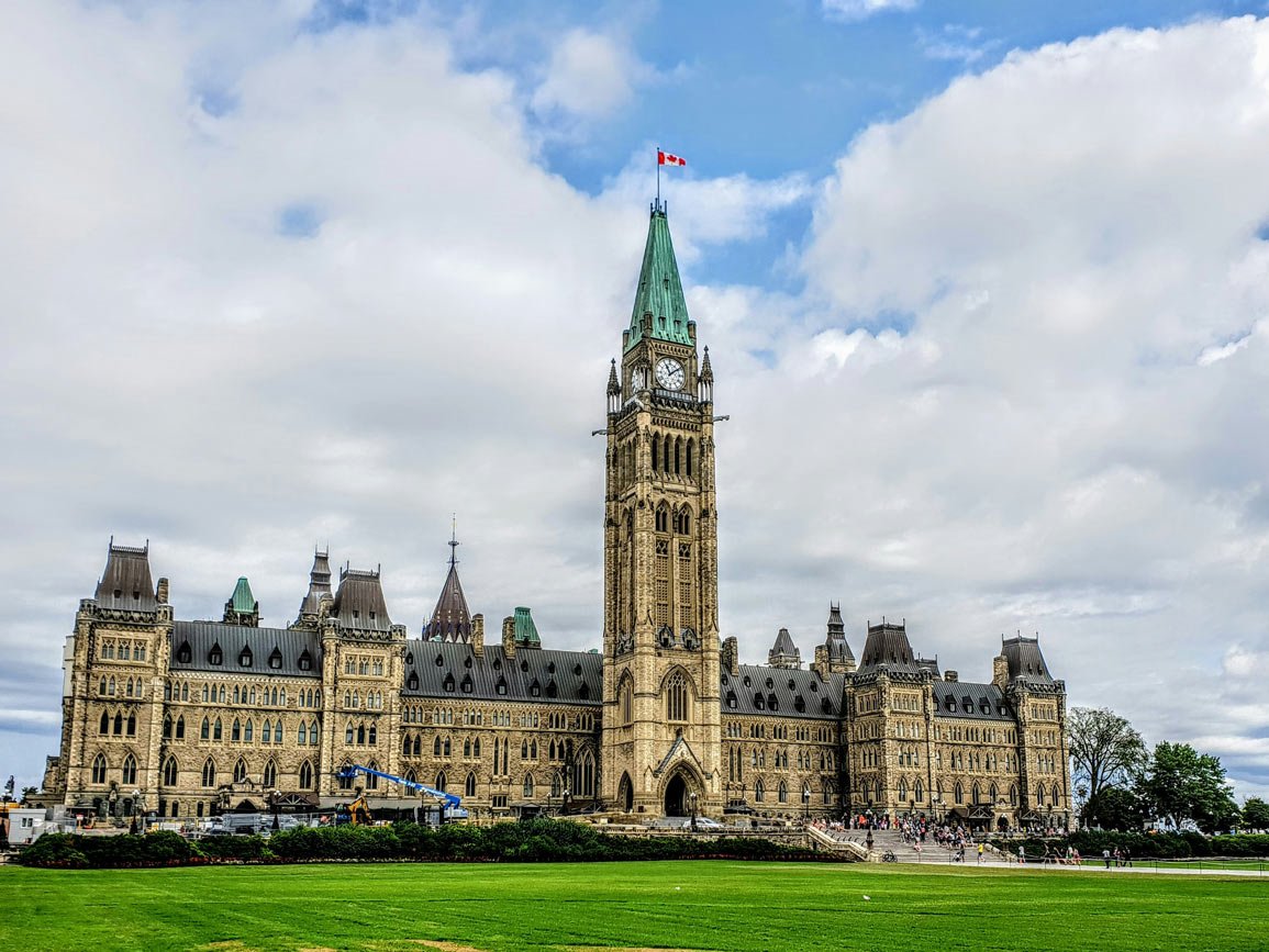 View of the Canadian parliament in Ottawa against a blue sky with clouds