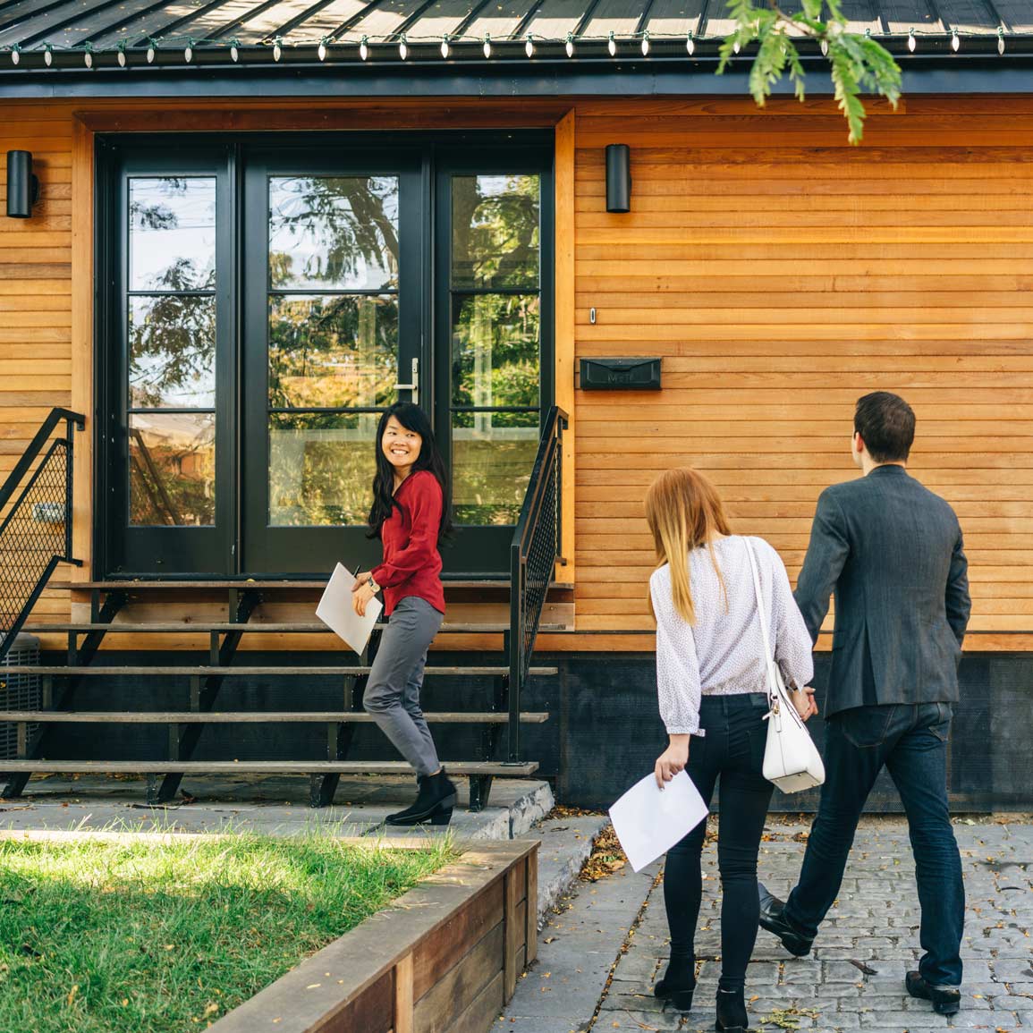 Real estate agent showing property to male and female clients